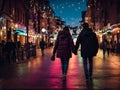 Couples walking hand in hand at night with bright lights