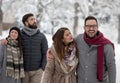 Couples walking in park on snow Royalty Free Stock Photo