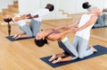 Couples yoga classes in modern fitness center