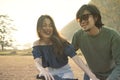 couples of younger asian man and woman practice to riding bicycle in natural field relaxing emotion