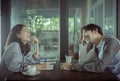 Couples of younger asian man and woman relaxing with hot coffee