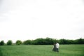 Couplewalking holding hands and walking in a green flowers field Royalty Free Stock Photo