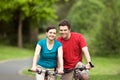 Couply Smiling on Bicycyles - horizontal Royalty Free Stock Photo