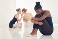 Courage is fire, and bullying is smoke. a ballet dancer sitting away from the crowd looking nervous and stressed. Royalty Free Stock Photo