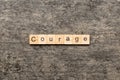 Courage word written on wood block. Courage text on cement table for your desing, concept Royalty Free Stock Photo