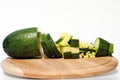 Courgette diced in different ways on wooden board