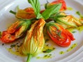 Courgette flowers stuffed with pizzottella and some tomato