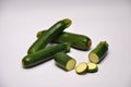 Whole and sliced courgettes on a seamless background Royalty Free Stock Photo