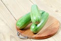 Courgettes zucchini on cutting Board on wooden table