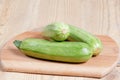 Courgettes zucchini on cutting Board on wooden table