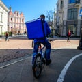 Courier On Bicycle Delivering Food European City