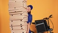 Courier burdened by huge pile of pizza