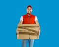 Courier with damaged cardboard box on background. Poor quality delivery service Royalty Free Stock Photo