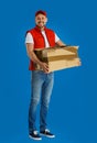 Courier with damaged cardboard box on background. Poor quality delivery service Royalty Free Stock Photo