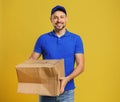 Courier with damaged cardboard box on background. Poor quality delivery service Royalty Free Stock Photo