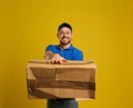 Courier with damaged cardboard box on background. Poor quality delivery service Royalty Free Stock Photo