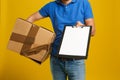 Courier with damaged cardboard box and clipboard on background, closeup. Poor quality delivery service Royalty Free Stock Photo