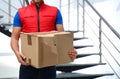 Courier with damaged cardboard box indoors. Poor quality delivery service Royalty Free Stock Photo