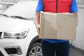 Courier with damaged cardboard box, closeup. Poor quality delivery service Royalty Free Stock Photo