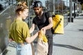 Courier delivering fresh food for a young woman