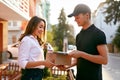 Courier Delivering Package To Woman. Client Receiving Box Royalty Free Stock Photo