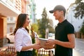 Courier Delivering Package To Woman. Client Receiving Box Royalty Free Stock Photo