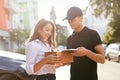 Courier Delivering Package To Woman, Client Signing Document Royalty Free Stock Photo