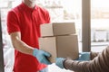Courier delivers packages in medical gloves at home