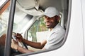 Courier Delivery. Black Man Driver Driving Delivery Car Royalty Free Stock Photo