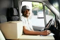 Courier Delivery. Black Man Driver Driving Delivery Car Royalty Free Stock Photo