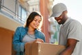 Courier Delivery Service. Man Delivering Package To Woman Royalty Free Stock Photo