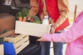 Courier giving crate with products to client outdoors. Food delivery service