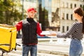 Courier Giving Pizzas Boxes To Girl Delivering Food Standing Outside