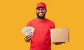 Courier Guy Holding Money Cash And Cardboard Box, Studio Shot Royalty Free Stock Photo