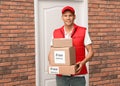 Courier holding parcels with stickers Free Delivery