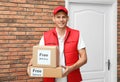 Courier holding parcels with stickers Free Delivery