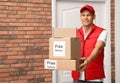 Courier holding parcels with stickers Free Delivery