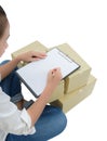 Courier making notes in delivery receipt among parcels on boxes Royalty Free Stock Photo