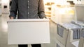 Courier man carrying white box in warehouse