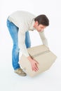 Courier man picking up cardboard box