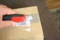 Courier package with a red knife, which just arrived at the recipient as a gift