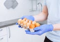 Courier in protective medical gloves delivers box with eggs stock for quarantine isolation period. Organic food and products Royalty Free Stock Photo