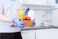 Courier in protective medical gloves delivers box with set food stock for quarantine isolation period. Online food store and Royalty Free Stock Photo