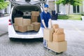 Courier pushing a dolly with packages Royalty Free Stock Photo