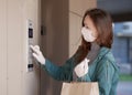 Courier`s hands in black medical gloves deliver parcels in paper bag to the door during the epidemic coronovirus, COVID