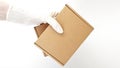 Courier`s hands in latex white medical gloves deliver parcels in brown cardboard boxes to the door during the epidemic of