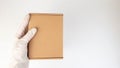 Courier`s hands in latex white medical gloves deliver parcels in brown cardboard boxes to the door during the epidemic of