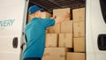 Courier Takes out Cardboard Box Package from Openned Delivery Van To Deliver Postal Parcel to Cust Royalty Free Stock Photo