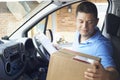 Courier In Van Delivering Package To Domestic House Royalty Free Stock Photo