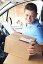 Courier In Van Delivering Package To Domestic House Royalty Free Stock Photo